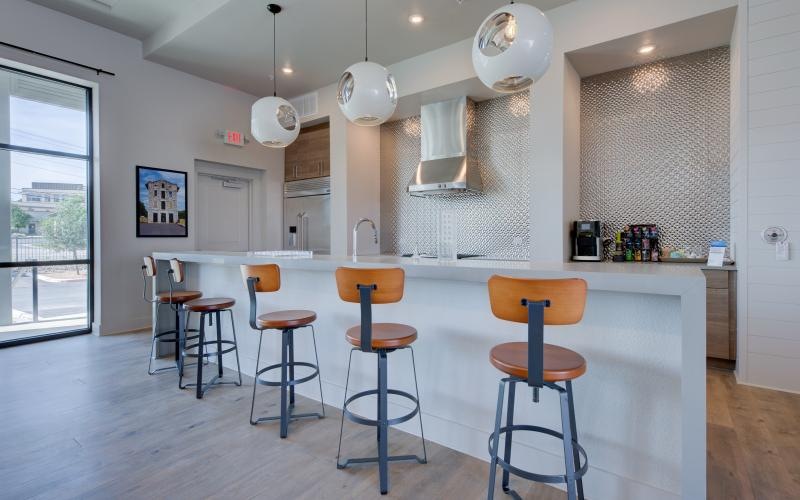 a kitchen with a bar stools