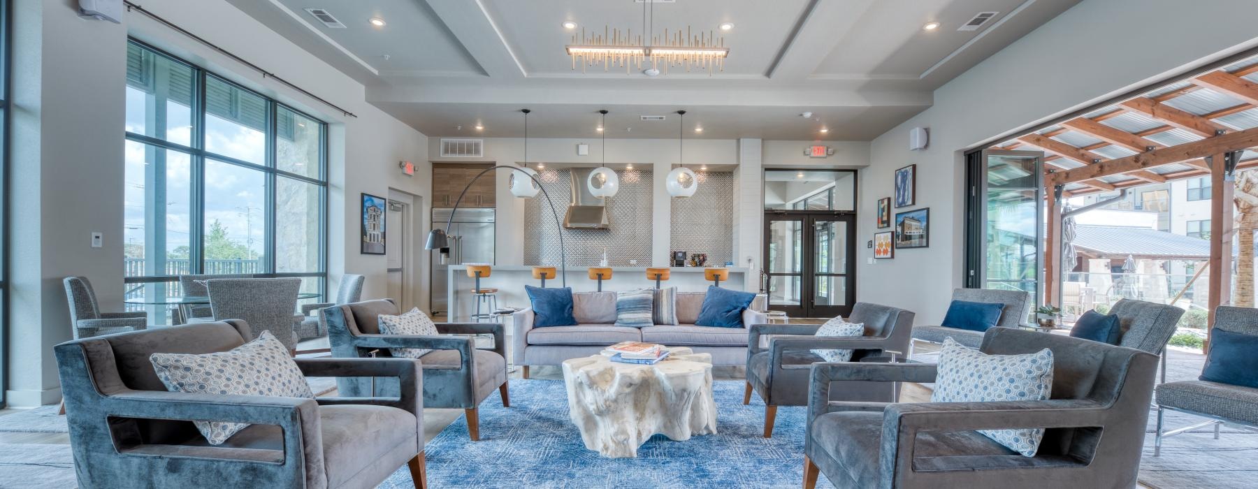 a room with a blue carpet and chairs and a chandelier